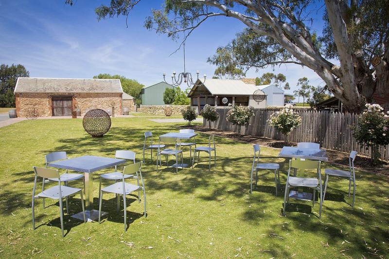 Tables and umbrellas set out on a cellar door lawn