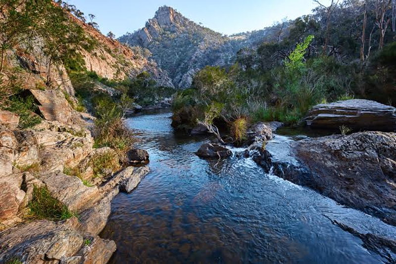 A rocky river gorge with a mountain peak rising ahead